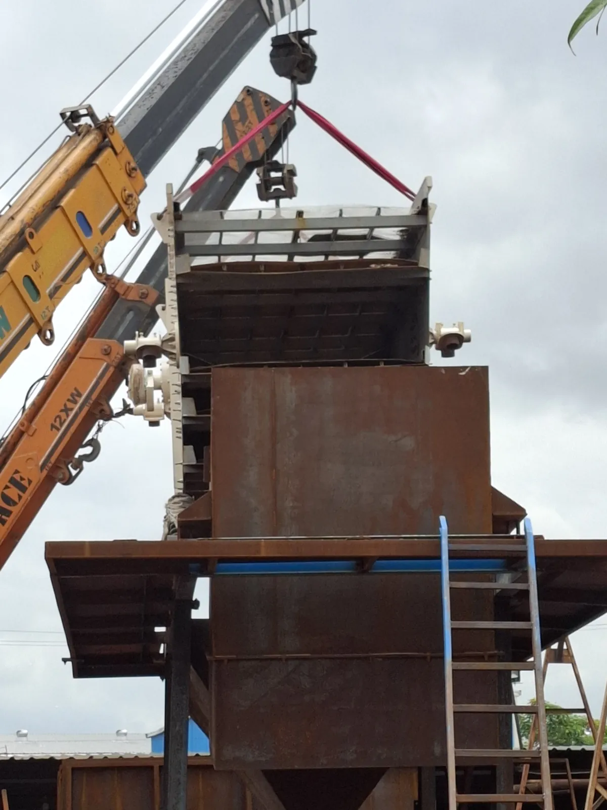 Surge hopper being lifted into place during plant installation